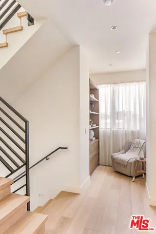 a view of a bedroom with furniture and a window