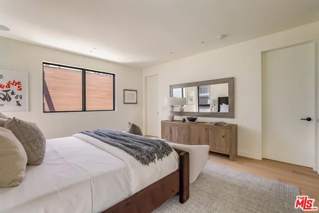 a bedroom with a large bed and a window