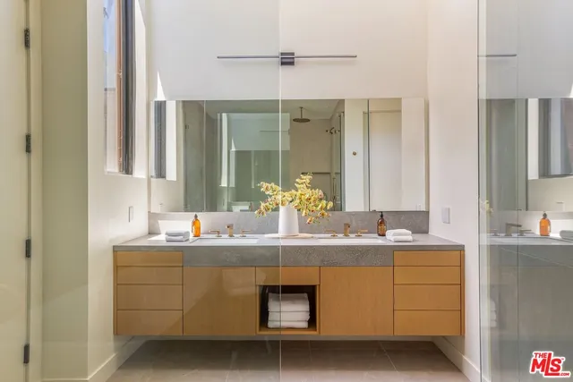 a bathroom with a double vanity sink and mirror
