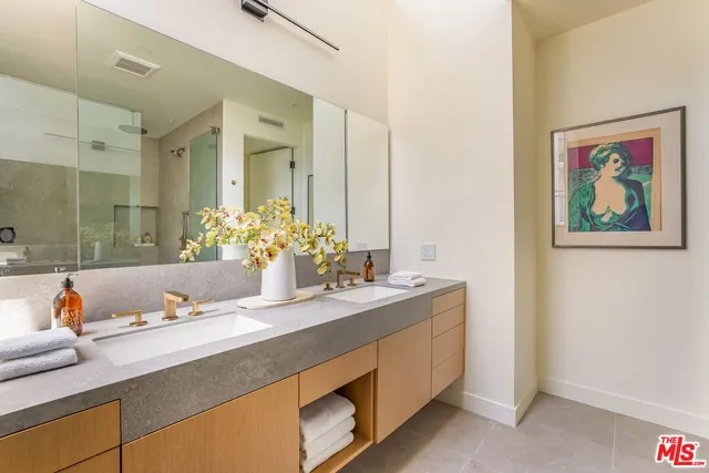 a bathroom with a granite countertop sink and a mirror