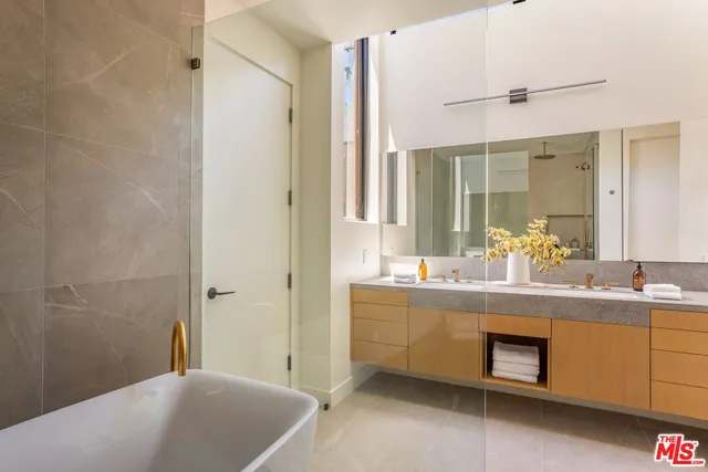 a bathroom with a bathtub sink and mirror