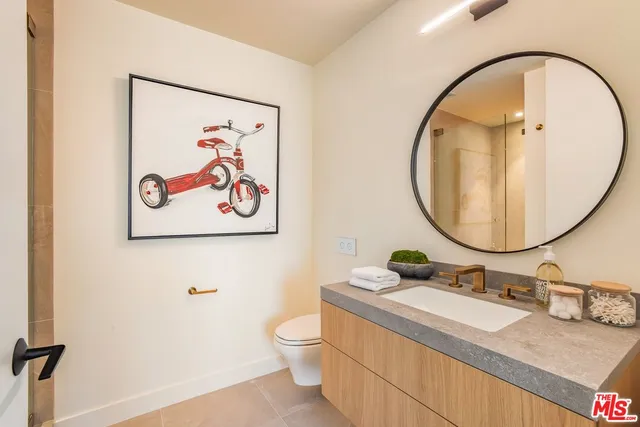 a bathroom with a sink mirror and toilet