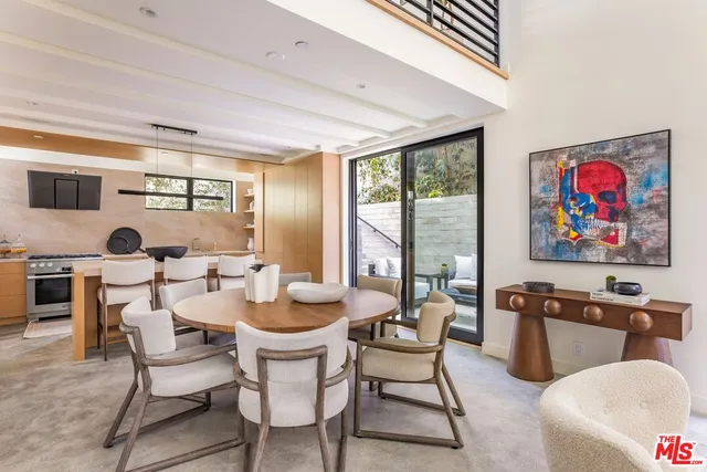 a dining room with furniture a flat screen tv and a floor to ceiling window