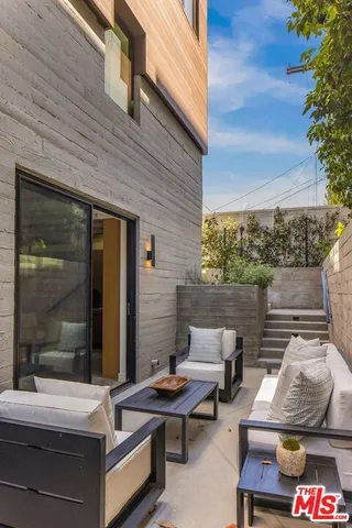 a outdoor sitting area with furniture and a potted plant