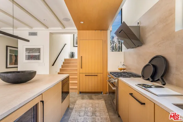 a kitchen with a sink and a stove top oven