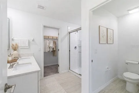 a bathroom with a sink toilet and shower