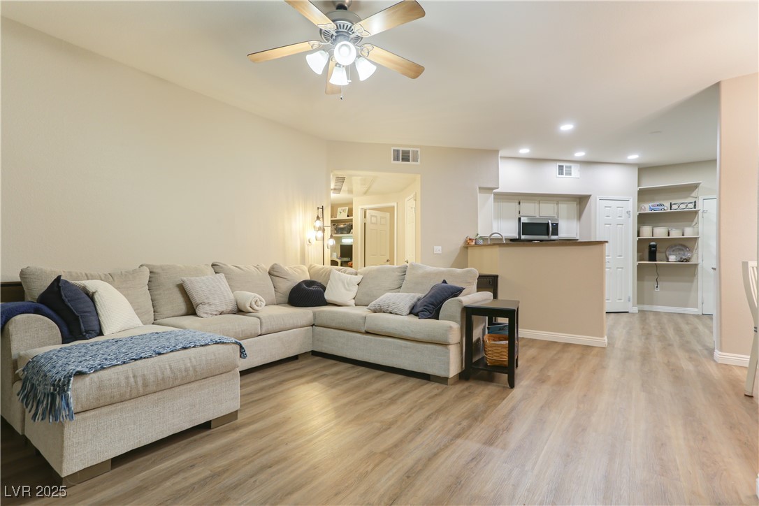 10550 West Alexander Road, Unit 1068 Las Vegas, NV 89129 - Photo 1 of 28 Living area featuring light wood finished floors, recessed lighting, and a ceiling fan