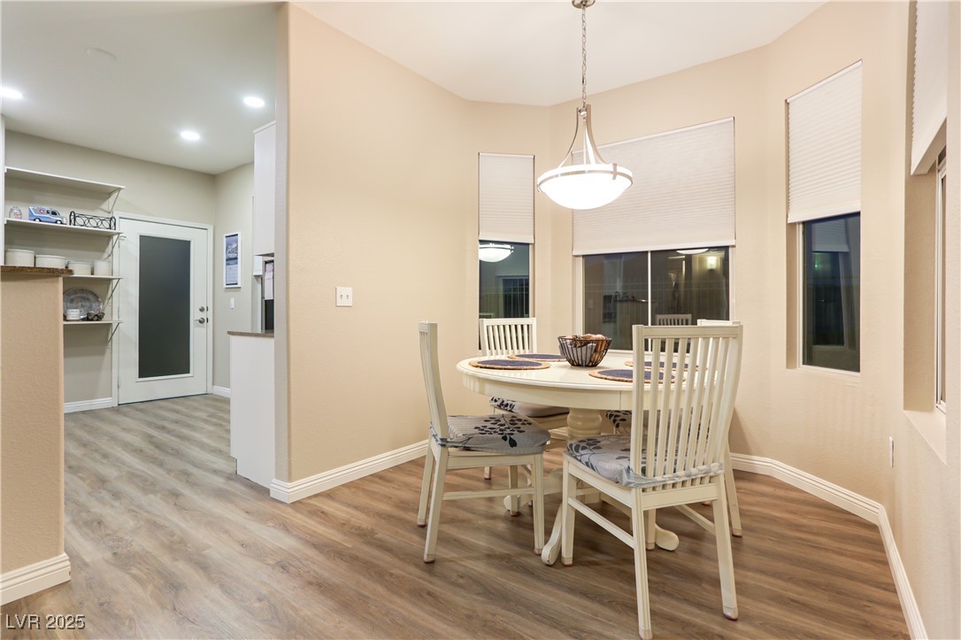 10550 West Alexander Road, Unit 1068 Las Vegas, NV 89129 - Photo 3 of 28 Dining space featuring wood finished floors and baseboards