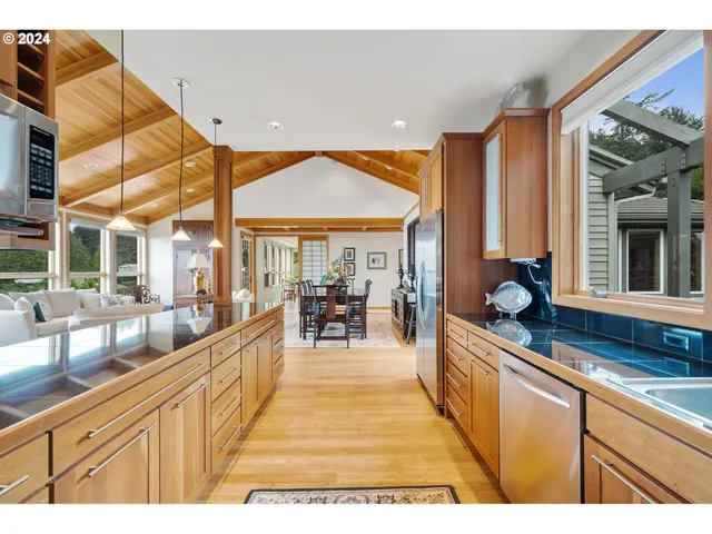 a very nice looking open kitchen with a large window