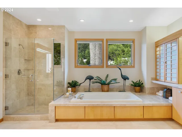 a bedroom with a large bed and a large mirror