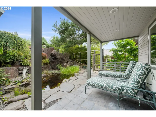a view of a patio with table and chairs potted plants with wooden floor