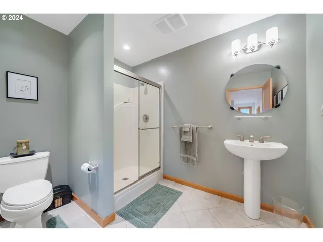 a bathroom with a sink toilet and a mirror