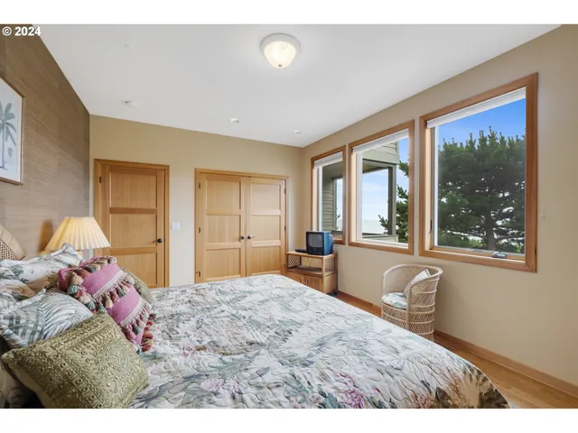 a bedroom with a large bed and a large window