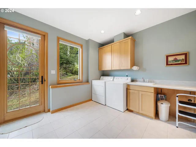 a kitchen with a sink cabinets and wooden floor