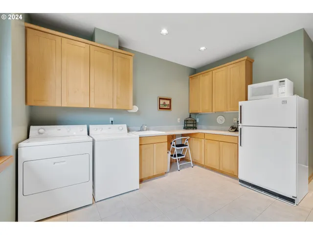 a kitchen with a refrigerator sink stove and cabinets