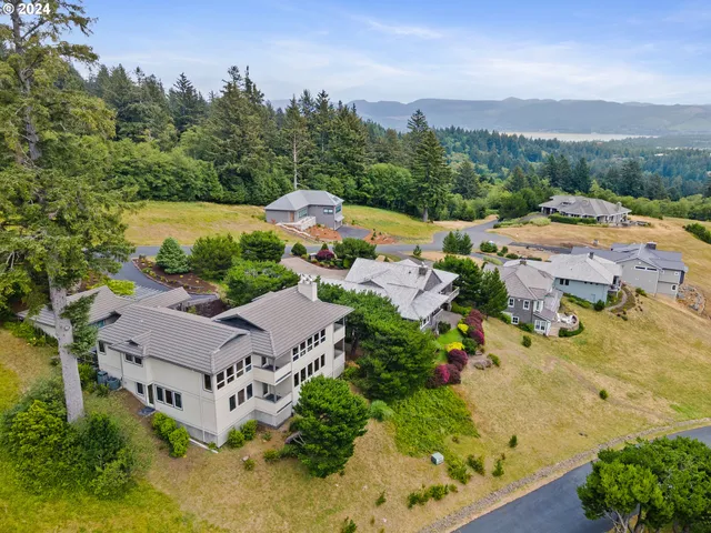 an aerial view of a house with a garden and lake view