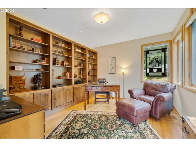 a living room with furniture a rug and a window
