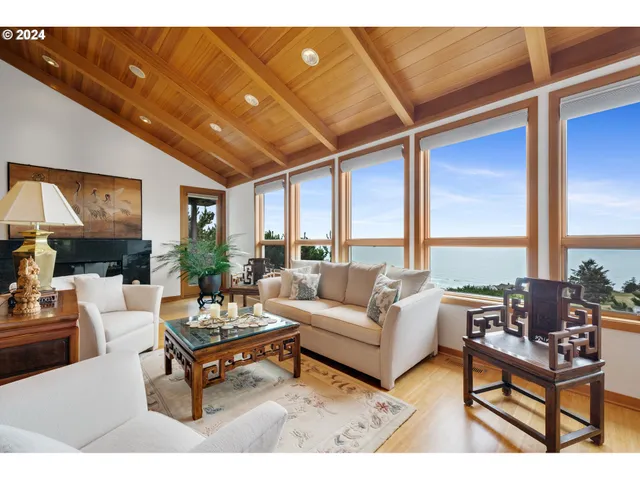 a living room with furniture a table and a large window
