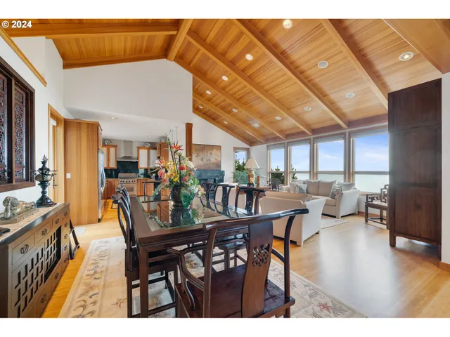 a dining room with furniture and wooden floor