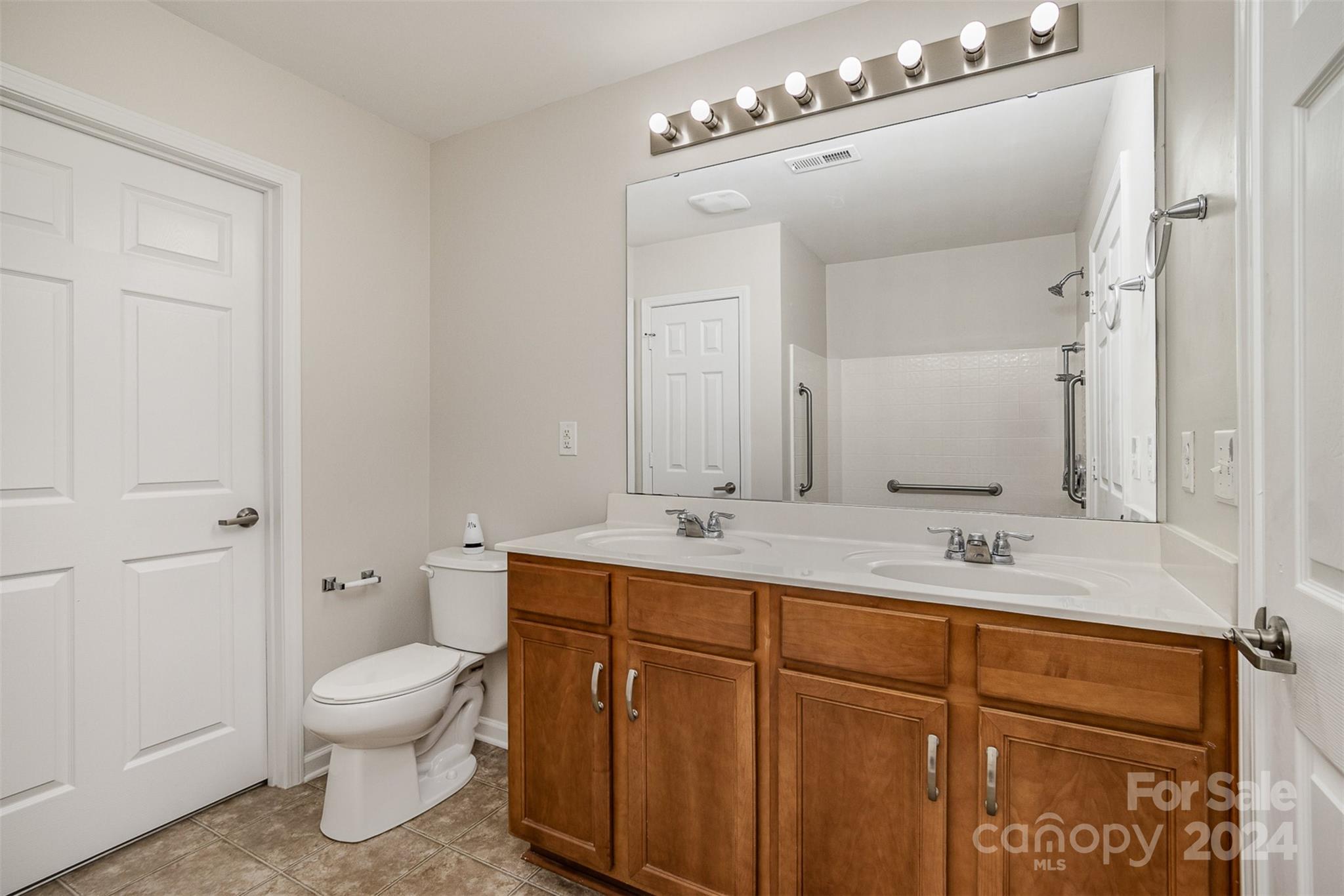 7006 Farm Pond Road Indian Trail, NC 28079 - Photo 19 of 37 a bathroom with a toilet sink and mirror