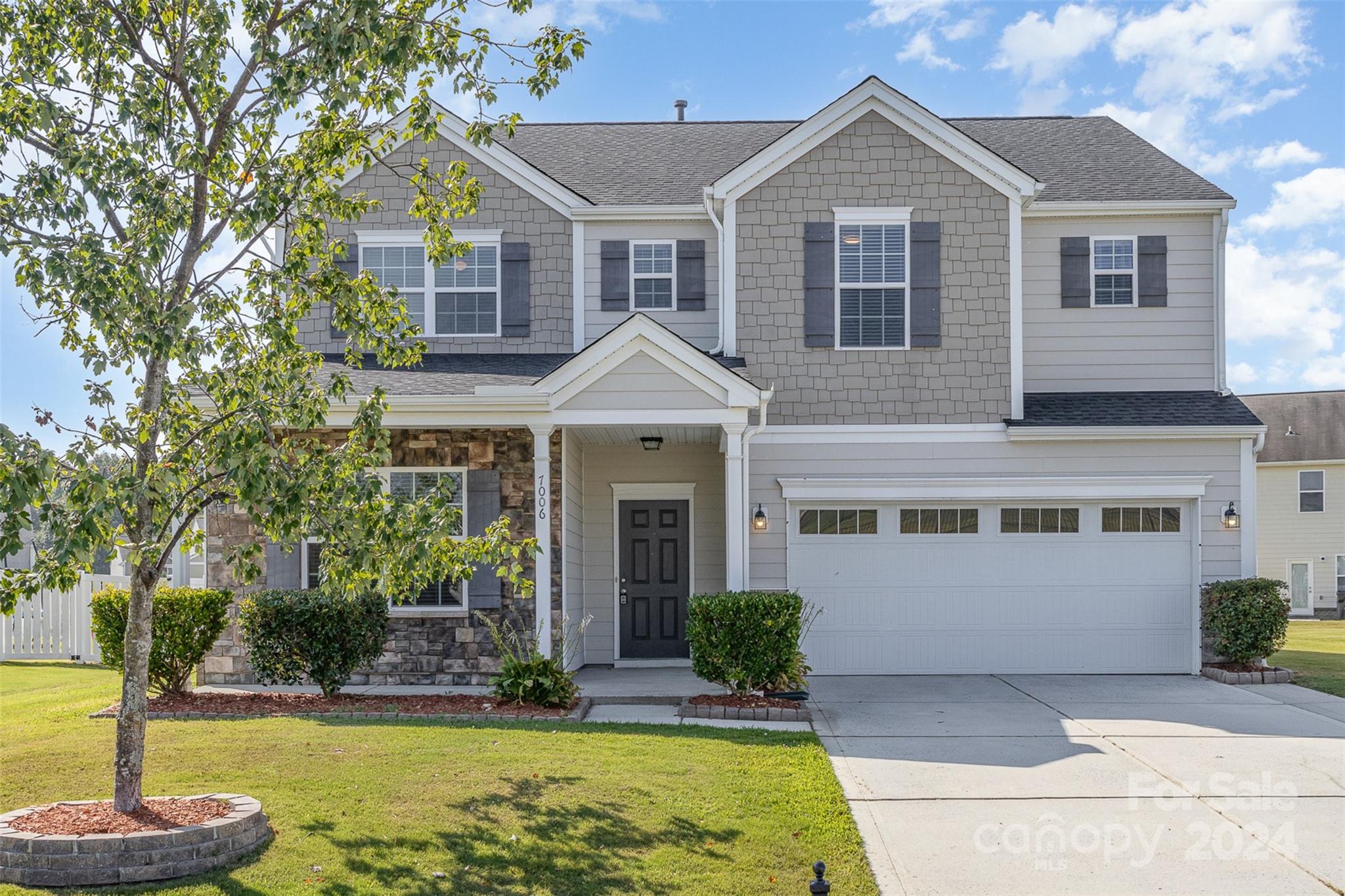 7006 Farm Pond Road Indian Trail, NC 28079 - Photo 3 of 37 a front view of a house with a yard and garage