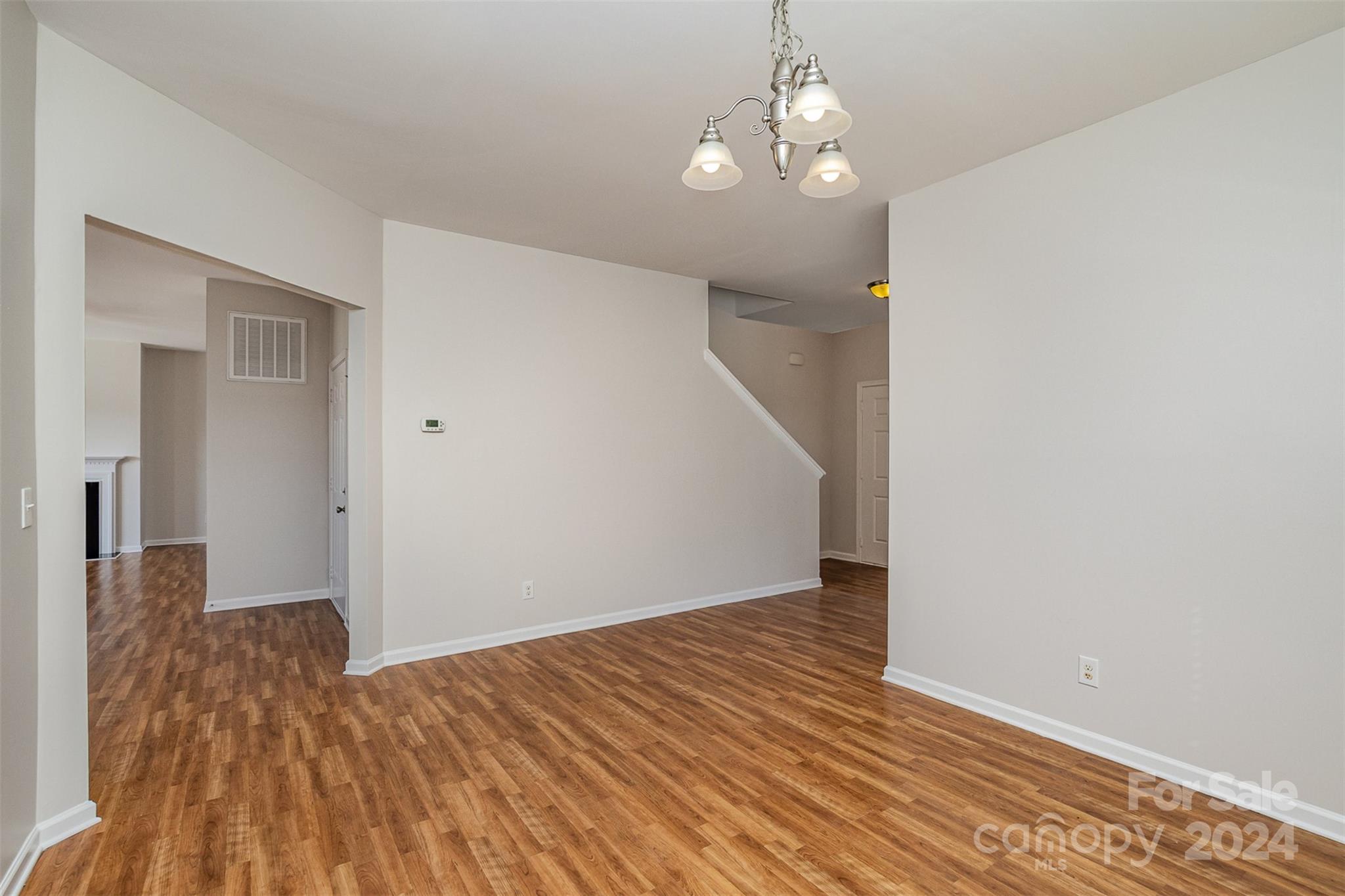 7006 Farm Pond Road Indian Trail, NC 28079 - Photo 5 of 37 wooden floor in an empty room with a window