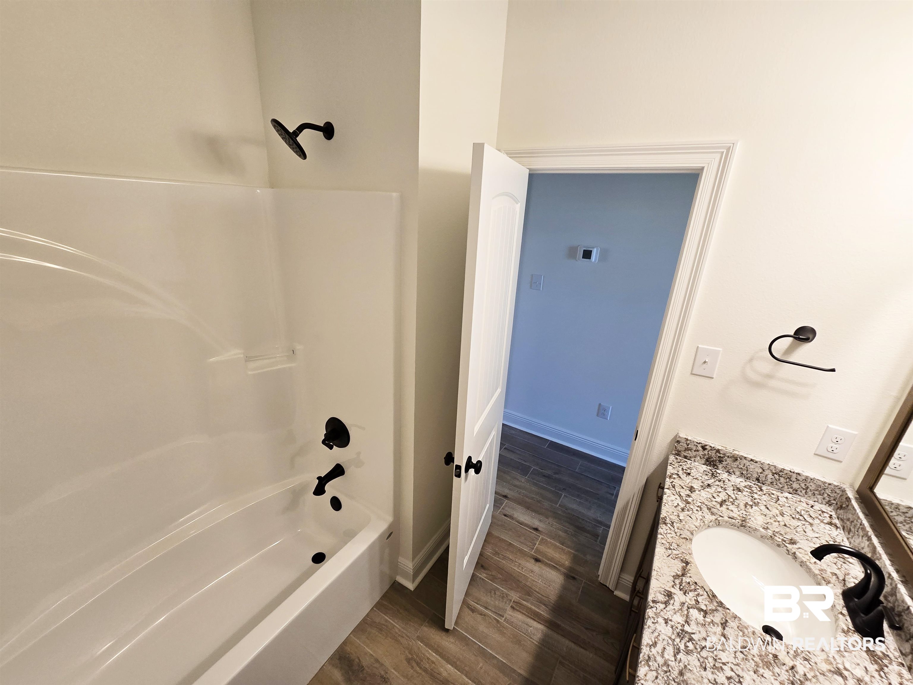 11178 Bonaventure Avenue Daphne, AL 36526 - Photo 17 of 20 Bathroom with vanity, wood tiled floors, and shower / bathtub combination