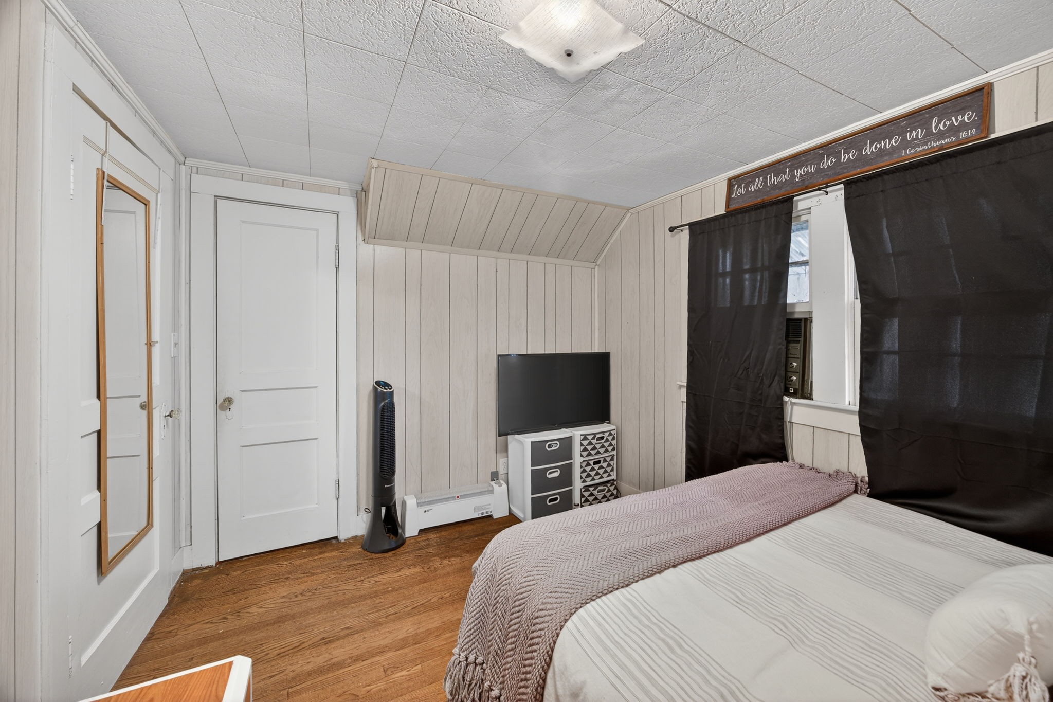 233 Buffalo Valley Road Baxter, TN 38544 - Photo 17 of 34 a bedroom with a bed and a flat tv screen on wall