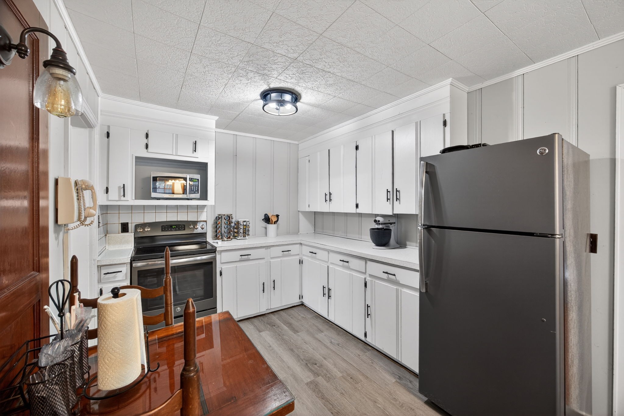233 Buffalo Valley Road Baxter, TN 38544 - Photo 8 of 34 a kitchen with stainless steel appliances a refrigerator sink and white cabinets