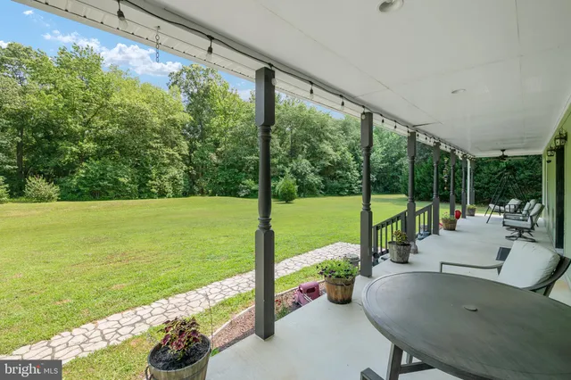 a view of a dining room with furniture and a chandelier