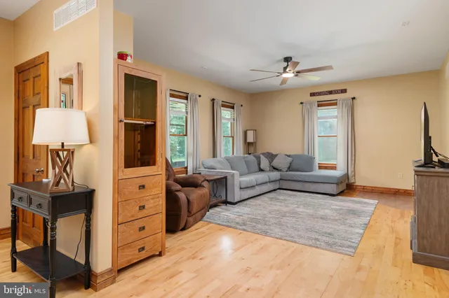 a kitchen with stainless steel appliances granite countertop a table chairs sink and cabinets