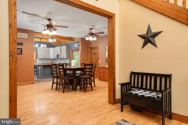 a kitchen with stainless steel appliances granite countertop a refrigerator a sink and white cabinets