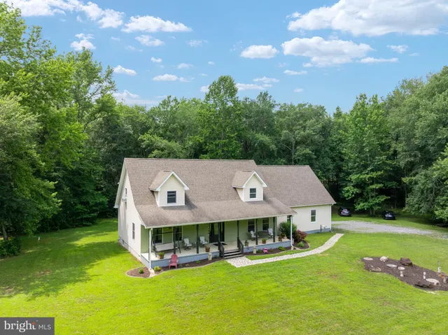 a aerial view of a house with swimming pool and yard