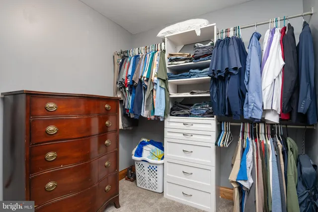 a view of walk in closet with empty room