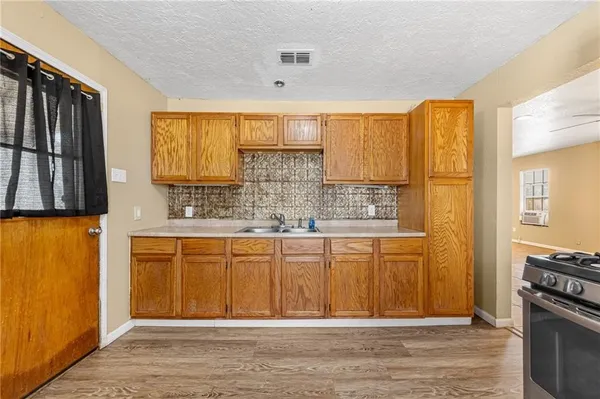 a view of kitchen with wooden floor and windows