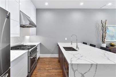 223 16th Street Northwest, Unit 6 Atlanta, GA 30363 - Photo 14 of 32 a kitchen with a sink a stove and chairs