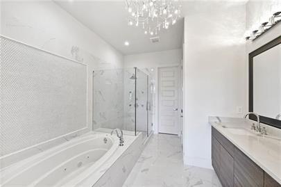 223 16th Street Northwest, Unit 6 Atlanta, GA 30363 - Photo 29 of 32 a spacious bathroom with a tub sink shower and mirror