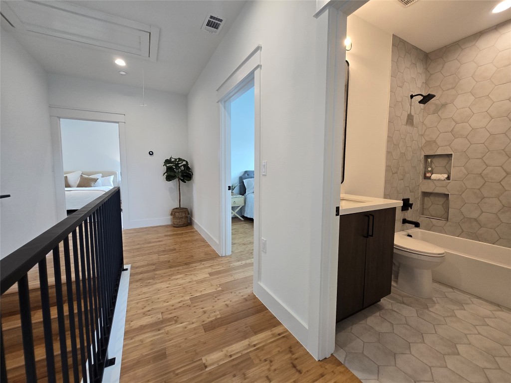 5301 Grover Avenue Austin, TX 78756 - Photo 27 of 40 Hallway with attic access, light wood-style flooring, and recessed lighting