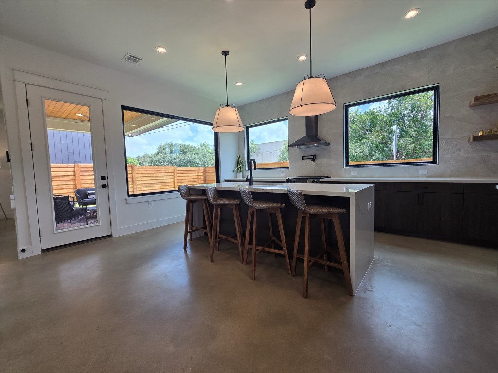 5301 Grover Avenue Austin, TX 78756 - Photo 4 of 40 Full wall of backsplash tile surrounding the huge windows, range hood, pot filler, reclaimed wood accent shelving, waterfall island countertop.