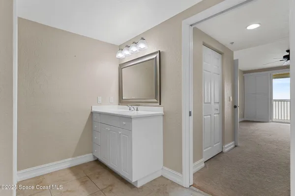 a bathroom with a sink a mirror and a vanity