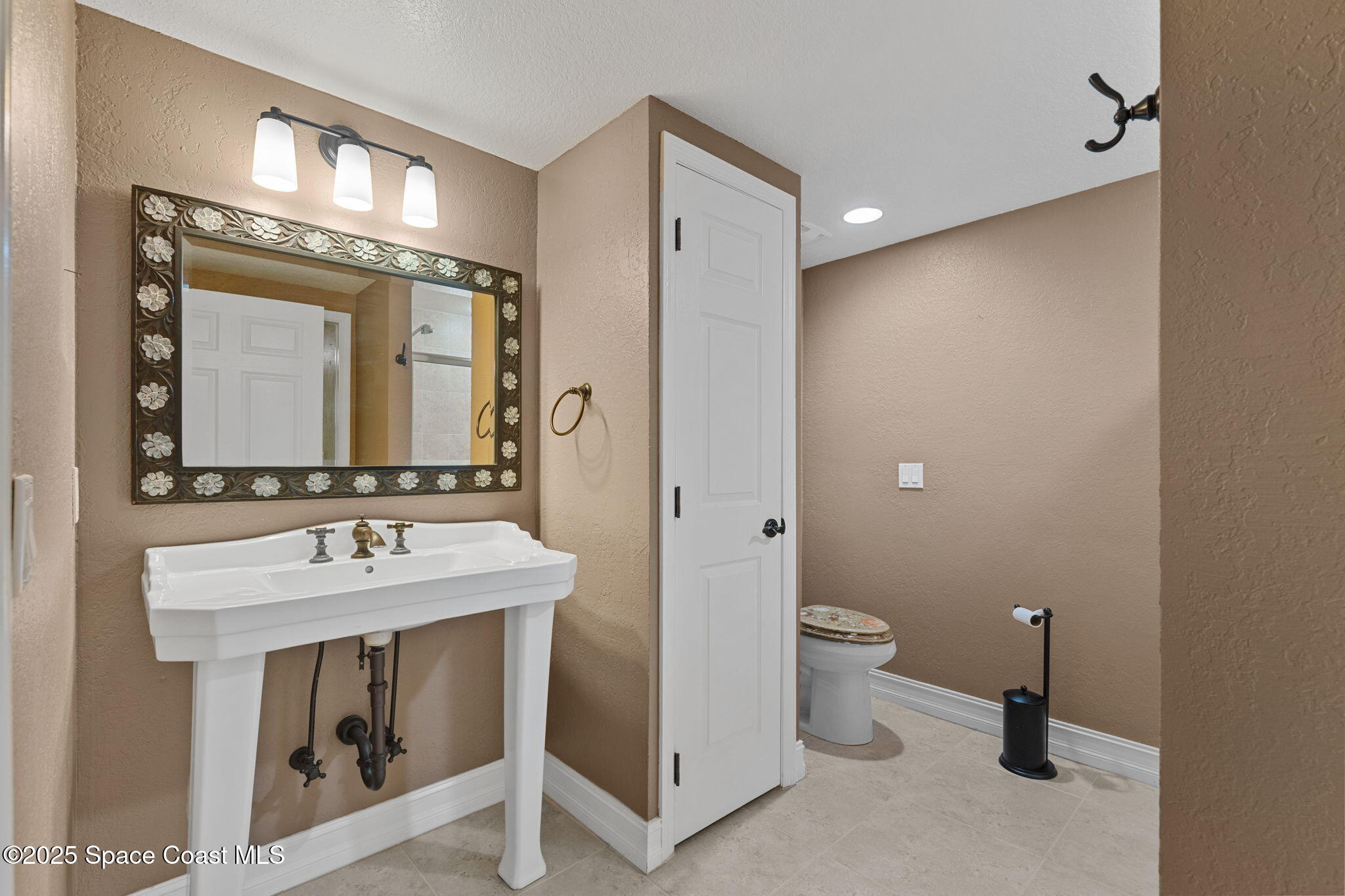 480 Sail Lane, Unit 204 Merritt Island, FL 32953 - Photo 18 of 32 a bathroom with a sink and a mirror