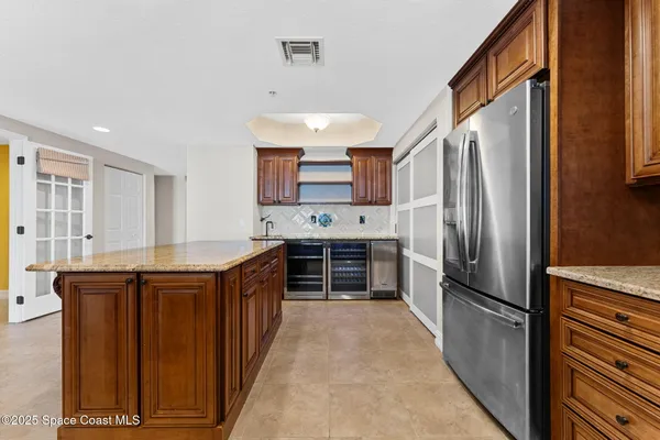 a kitchen with stainless steel appliances a refrigerator and a stove