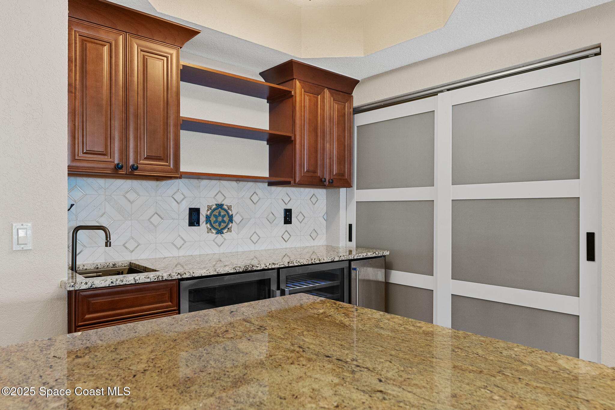 480 Sail Lane, Unit 204 Merritt Island, FL 32953 - Photo 8 of 32 a kitchen with stainless steel appliances granite countertop a sink and a stove