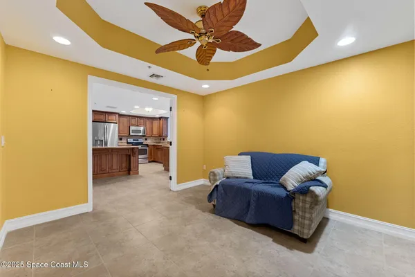 a living room with furniture and kitchen view
