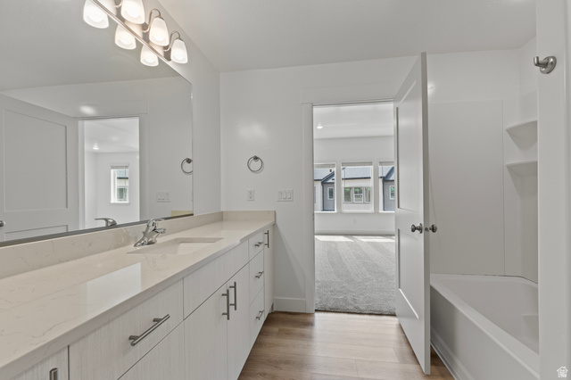 3410 South 1010th Street West Logan, UT 84321 - Photo 9 of 15 Full bath with vanity, light wood finished floors, and light carpet
