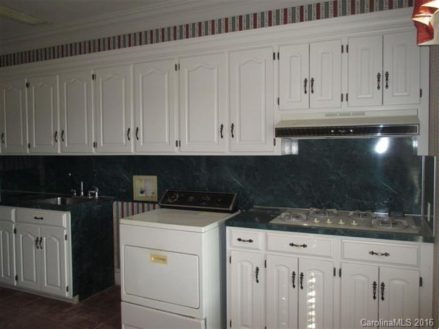 2741 South Potter Road Heath Springs, SC 29058 - Photo 14 of 24 a kitchen with white cabinets and sink