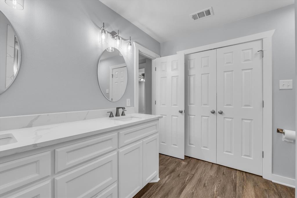 3608 North 26th Street Waco, TX 76708 - Photo 14 of 28 a bathroom with a sink and a mirror