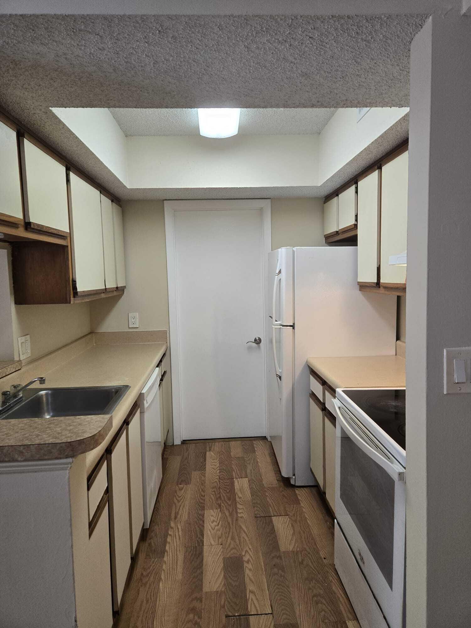 5780 Rock Island Road, Unit 367 Tamarac, FL 33319 - Photo 1 of 13 a kitchen that has a sink and a stove in it