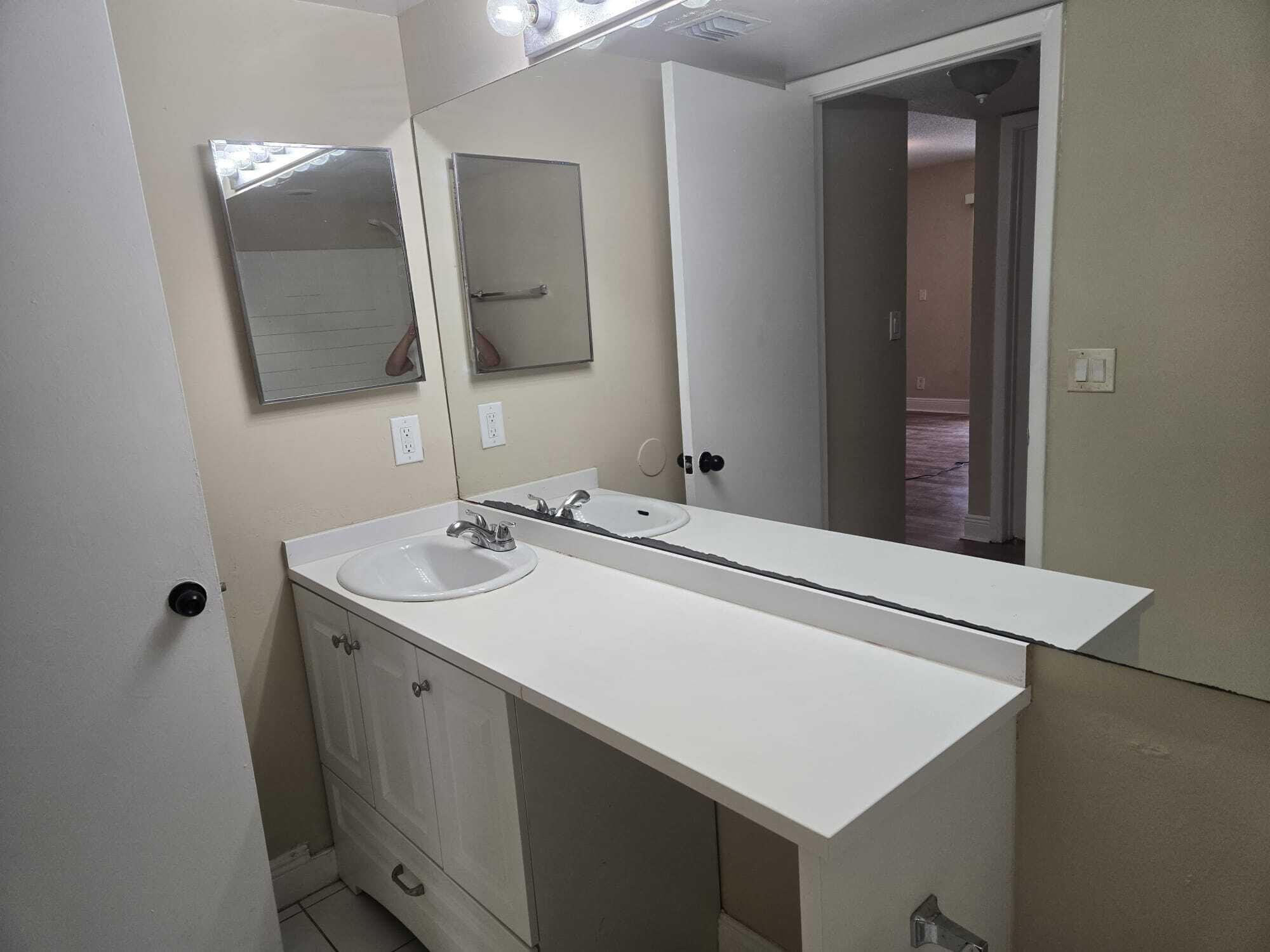 5780 Rock Island Road, Unit 367 Tamarac, FL 33319 - Photo 4 of 13 a bathroom with a sink and a mirror