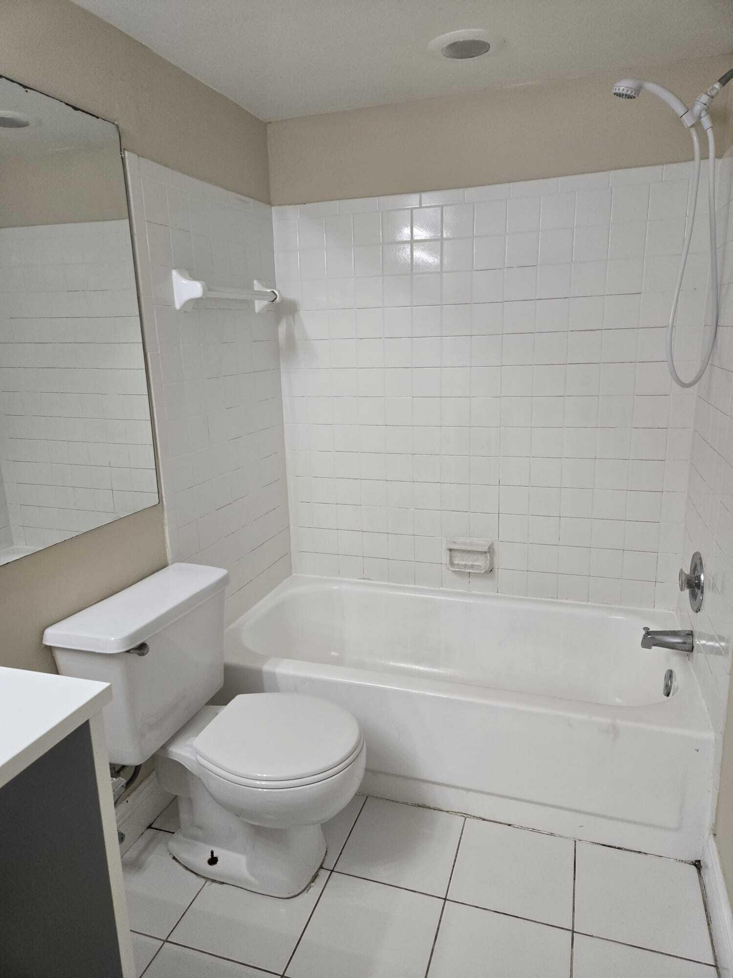 5780 Rock Island Road, Unit 367 Tamarac, FL 33319 - Photo 5 of 13 a bathroom with a toilet and a bath tub